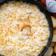 This 1-pan hot shrimp artichoke dip is the perfect holiday appetizer. This shrimp dip is easy, creamy, cheesy, fully loaded, and boy is it ever good! | natashaskitchen.com