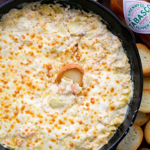 This 1-pan hot shrimp artichoke dip is the perfect holiday appetizer. This shrimp dip is easy, creamy, cheesy, fully loaded, and boy is it ever good! | natashaskitchen.com