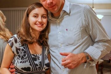 Natasha and her husband smiling in a kitchen