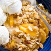 This Peach Crisp is our favorite summer peach recipe. The peach juices bubbling under the crisp buttery crunchy topping is completely irresistible. Add a generous dollop of vanilla ice cream! | natashaskitchen.com