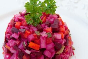 Russian vinaigrette salad with beets and sauerkraut on a white plate