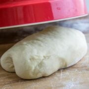 A ball of dough on a floured cutting board