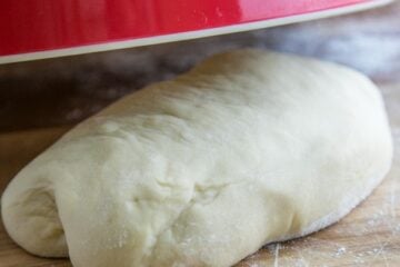 A ball of dough on a floured cutting board