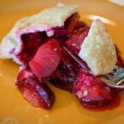 Plum good pie on an orange plate