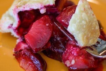 Plum good pie on an orange plate