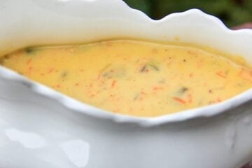 A white, gravy bowl with mushroom gravy