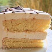 This ptichye moloko cake has mousse sandwiched between biskvit cake layers with a light syrup and a very simple creme chantilly frosting.