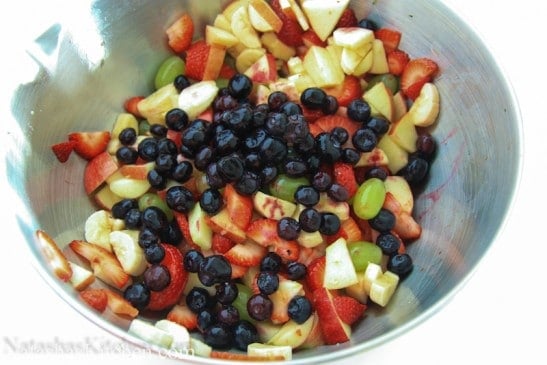 A large mixing bowl of different fruits 