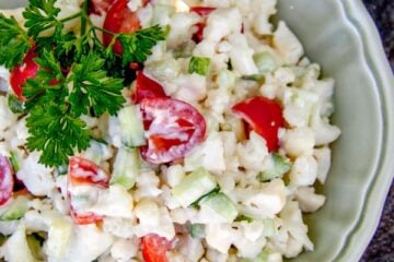A bowl do cauliflower, cucumber and tomato salad