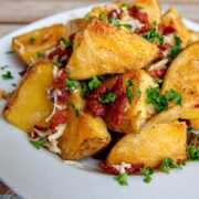 Oven-roasted potatoes with bacon and cheese in a plate