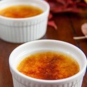 Two white glass bowls with pumpkin creme br&ucirc;l&eacute;es