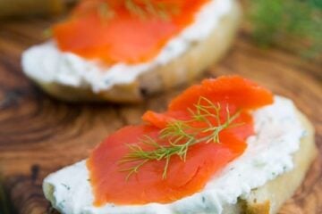These smoked salmon tea sandwiches (crostini) show up at 90% of our parties. Everyone loves them. The cream cheese dill spread is wonderful!