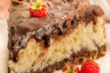 This Cheese Chocolate Cake has a generous layer of farmers cheese sandwiched between two layers of chocolate crust and covered with a chocolate glaze.