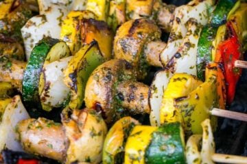 A close up of Moroccan vegetable skewers on a grill