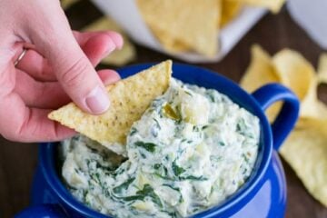 This skinny spinach and artichoke dip uses Greek yogurt. Serve it warm and cheesy. It's perfect for game day or any occasion.