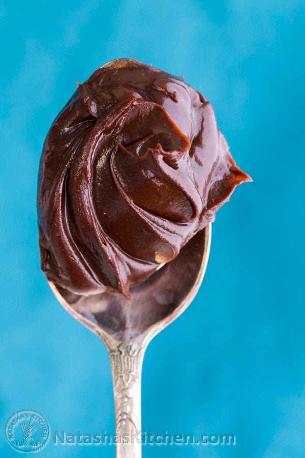 A close up of chocolate ganache on a spoon 