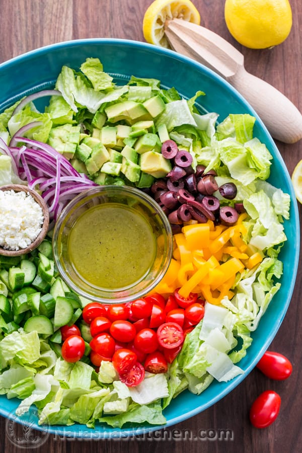 How to make Greek salad prepared in a mixing bowl with dressing in separate container