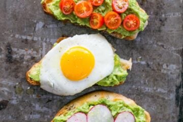 Five varieties of open-faced avocado spread sandwiches