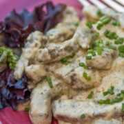 A plate of Russian beef stroganoff garnished with chives