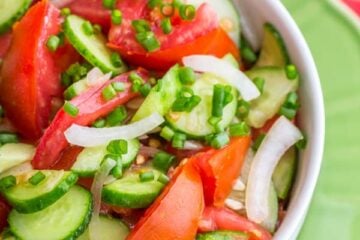 A bowl of cucumber and tomato salad
