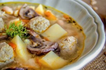 A white bowl of turkey meatball soup