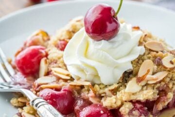 This Cherry Crumble is a family favorite! The crumbly crisp almond topping is a perfect match to those juicy plump cherries | NatashasKitchen.com