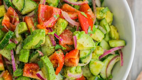 Cucumber Tomato Avocado Salad served in a white bowl