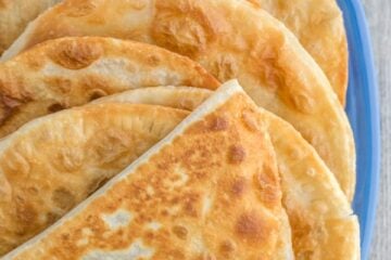 A close-up plate of cabbage and mushroom chebureki