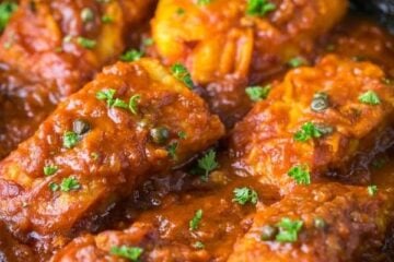 Cod fish in Tomato Sauce. The fish is flaky and juicy and the sauce is legit! | natashaskitchen.com