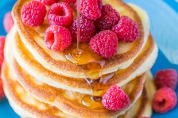These Greek yogurt pancakes aren't your standard pancakes! They are delicate and crisp on the edges - delicious!| natashaskitchen.com