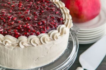 A moist Pomegranate Cake with a crown of glistening pom seeds. Pomegranate cake is fantastic top to bottom and makes for a stunning Christmas Cake! | natashaskitchen.com