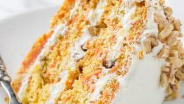 Carrot Walnut Cake slice on a plate with fork