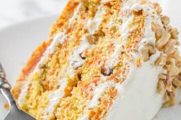 Carrot Walnut Cake slice on a plate with fork