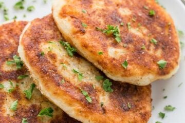 Mashed potato pancakes are a creative way to use leftover mashed potatoes! These are stuffed with a juicy meat filling - delicious! | natashaskitchen.com