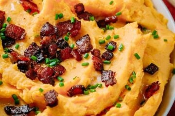 A savory mashed sweet potatoes recipe. Combining yukon and sweet potatoes is brilliant! A perfect holiday side dish. Super easy and seriously delicious. #thanksgiving #natashaskitchen #easysidedish #sweetpotatoes