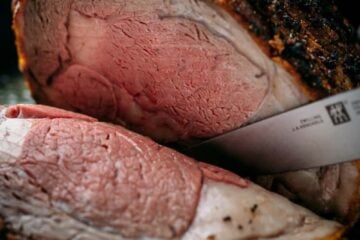 A garlic-crusted Prime Rib Recipe with a trusted method for juicy, melt-in-your-mouth tender prime rib roast. Watch the video tutorial and learn how to trim, tie, wrestle (kidding), and cook prime rib.