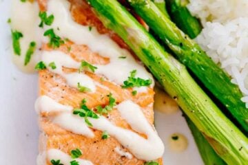 Oven Baked Salmon with flavorful and simple lemon cream sauce. Lemon beurre blanc, will be your secret weapon for seafood recipes. Gourmet flavors at home! | natashaskitchen.com