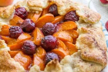 This apricot cherry galette is filled with the juicy apricots and sweet cherries with an easy and flaky pastry crust. Easy apricot cherry galette! | natashaskitchen.com