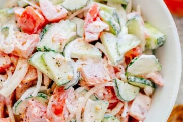 This CLASSIC creamy cucumber and tomato salad is so simple to make and is our go-to summer salad. An easy, excellent cucumber tomato salad. KEEPER! | natashaskitchen.com