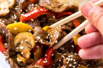 MUST TRY quick beef stir-fry recipe loaded with mushrooms, bell peppers and zucchini. Serve beef stir-fry over steamy white rice. The easy sauce will surprise you! | natashaskitchen.com