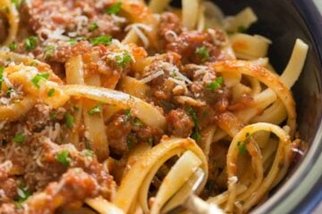 Good bolognese sauce (Italian Ragu) is cooked slowly, puttering away as deep meaty flavors develop. This slow cooker bolognese recipe couldn't be easier! | natashaskitchen.com