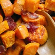 Maple Roasted sweet potatoes with bacon and serving spoon