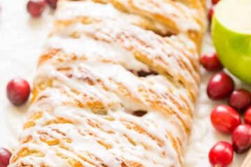 An Apple Danish Braid loaded with juicy caramelized apples and cranberries in a flaky pastry shell. This braided apple danish is easy and disappears fast! | natashaskitchen.com