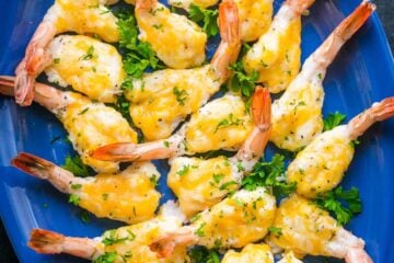 This is a fly-off-the-plate cheesy garlic shrimp appetizer and it&rsquo;s so easy to make! Easy, excellent butterflied shrimp appetizer! | natashaskitchen.com
