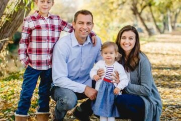 A photo of Natasha and her family in fall leaves