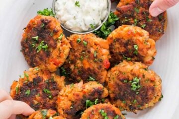 These salmon cakes are crisp on the outside with tasty bites of flaked salmon. They always disappear fast! SUPER EASY and truly delicious salmon cakes! | natashaskitchen.com