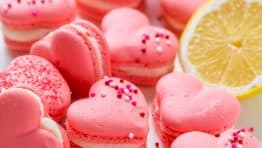 Heart Macarons are easier than you think! Heart-shaped macarons with tangy-sweet lemon buttercream. Includes video tutorial + free printable heart template! | natashaskitchen.com