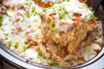 You'll make this slow cooker lasagna again and again! So saucy and cheesy! An easy make-ahead crockpot lasagna - the noodles cook right in the crockpot! | natashaskitchen.com