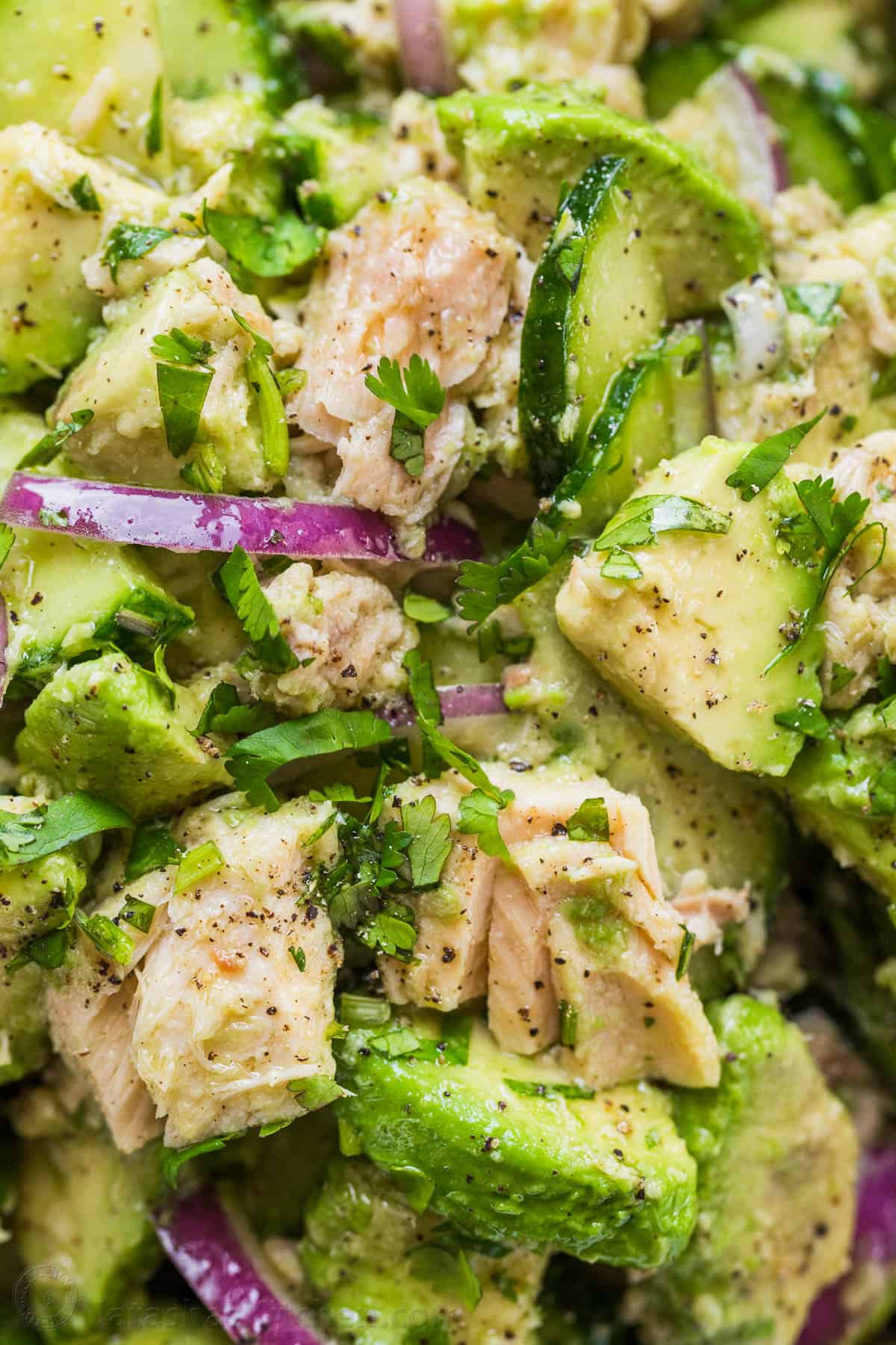 This Avocado Tuna Salad has incredible fresh flavor. It' is a high-protein salad and the avocado adds creaminess without any mayo. Up close textures of avocado tuna salad in a bowl