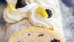 Fluffy and moist Blackberry Lemon Cake Roll (Swiss Roll) that's easier than you think! Impress everyone with this show-stopping Blackberry Lemon Cake Roll | natashaskitchen.com